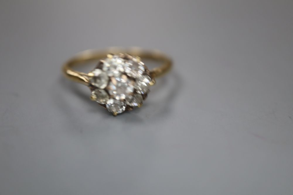 An early 20th century 18ct and old round cut diamond set cluster ring, size P, gross 2.2 grams.